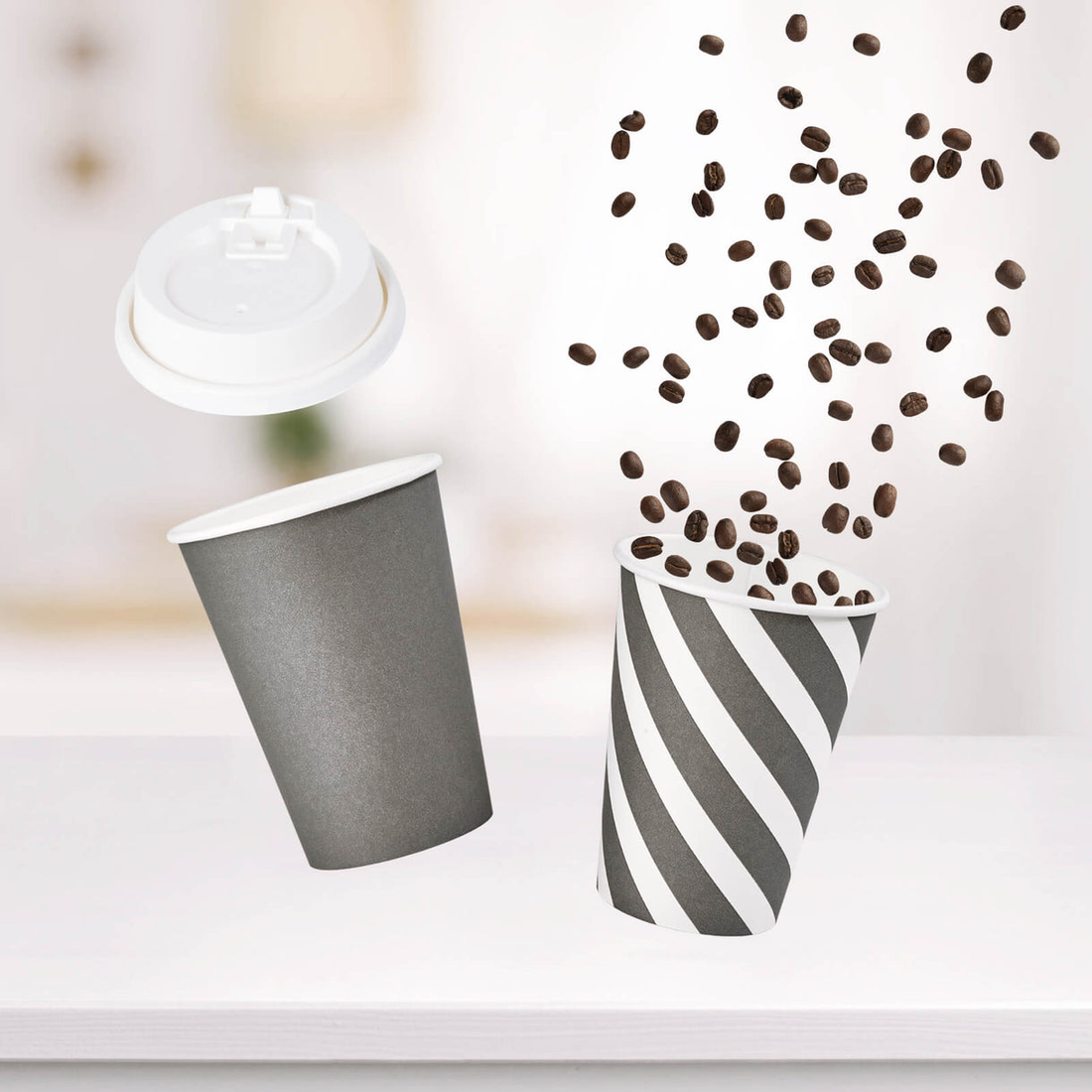 Two Jolly Chef coffee cups, one striped and one solid, with a lid and coffee beans falling through the air, set against a blurred background.