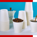A stack of white disposable Jolly Chef cups beside a moka pot, with one cup filled with coffee beans and another being poured with coffee.