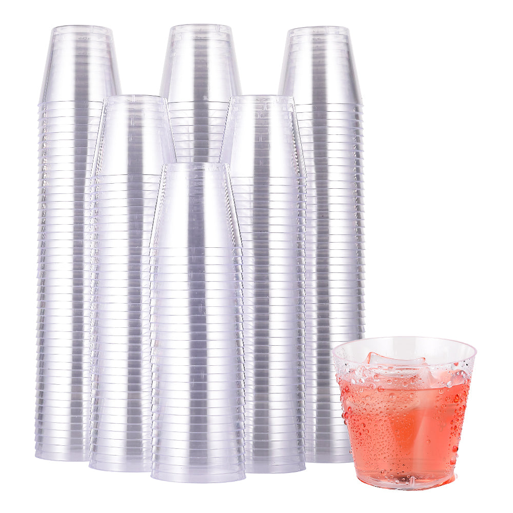A stack of Jolly Chef clear plastic cups with one containing a fizzy pink drink and ice, arranged on a white background.