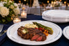 Heavy-duty plastic plates stacked for steak dinners