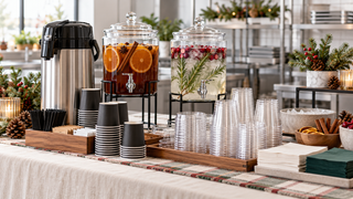 Holiday office drink station with clear PET cups, compatible lids, black coffee cups, and napkins