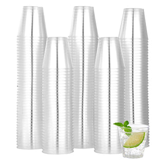 Five stacked clear Jolly Chef plastic cups behind a glass of sparkling water with lime and mint garnish.