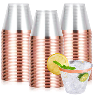 Three Jolly Chef Gold&Rose&Silver Rim Plastic(PS) Cups with copper rims stacked together, beside a clear glass filled with ice, mint, and lemon slices.