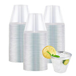 Stack of clear plastic tumblers with a single filled cup showing ice, lemon, and lime.
