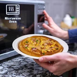 A hand holds a jolly chef plate with a meat and vegetable pizza, close to a microwave oven labeled "Microwave Oven."