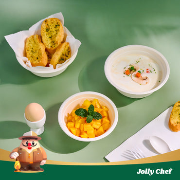 A colorful meal display featuring garlic bread, fresh mango salad, creamy soup, and an egg, set on a green background. Jolly Chef logo included.