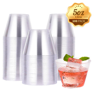 A stack of clear Jolly Chef plastic cups with a label showcasing "5oz Clear 100 Pack," alongside a glass of a pink drink with ice and mint.