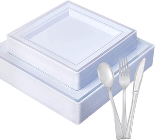 A stack of Jolly Chef Gold&Silver Rim Black&White Square Plastic Plates & Flatwares(25 sets)with a silver spoon, fork, and knife arranged beside them.