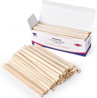 Wooden coffee stirrers in box and pile. Disposable stir sticks.