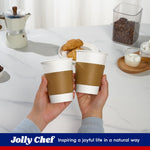 Hands holding two white paper coffee cups with brown corrugated sleeves