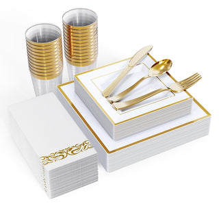 Elegant disposable tableware set: gold-rimmed plates, cups, cutlery, and decorative napkins.