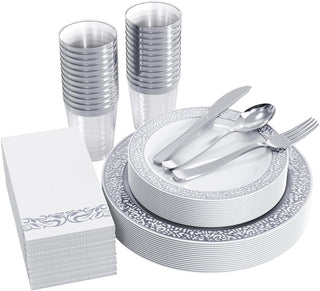 Elegant disposable dinnerware set: plates, cutlery, cups, and napkins with silver accents for parties and events.