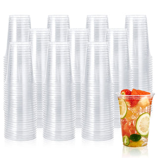 Bulk clear PET plastic cups filled with ice, fruit slices, and berries, with a stack of empty cups behind.