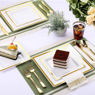 Elegant dessert table setting with gold-rimmed plates and cake