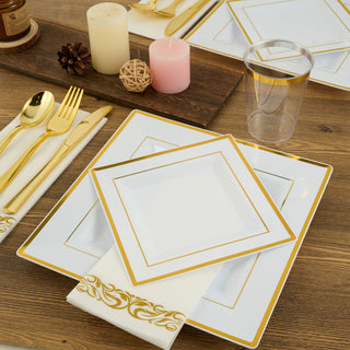 Elegant white and gold party plates, cutlery, and napkins on a wooden table.