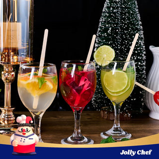 Festive cocktails with fruit slices, wooden stirrers, and a small Christmas tree. Jolly Chef logo in the corner.