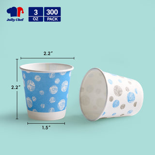 Two JOLLY CHEF 3 oz Paper Cups – 300 Count, Small Bathroom Cups, Disposable Mouthwash Cups, Espresso Cups, Mini Cup for Coffee, Tea, Water, Snack, one with a blue pattern and the other with gray and blue spots, sit against a mint green background.