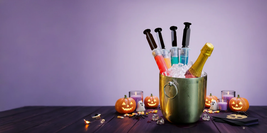 Halloween party: Spooky cocktails in syringes, champagne in ice bucket, pumpkins and ghost decorations.