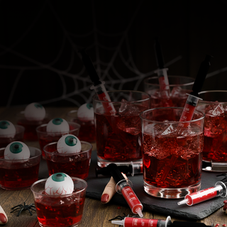 Halloween cocktails with syringes and eyeballs, spooky party drinks