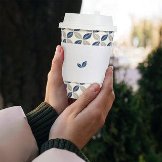 An individual hold a Jolly Chef 12 oz disposable coffee cup