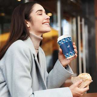 A women is holding Jolly Chef 12oz disposable coffee cup and enjoying bagels with coffee