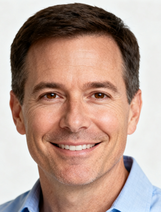 Smiling man with kind eyes and a blue shirt