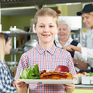 A child is holding a Jolly Chef 10*8 inches compostable disposable 5 compartment paper plate filled with food