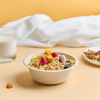 Jolly Chef 16oz disposable paper bowl filled with cereal served with glass of milk