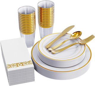 Elegant disposable dinnerware: plates, cutlery, cups, napkins with gold accents for party or event.
