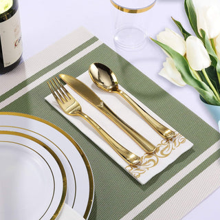 Elegant table setting with gold cutlery, white plates, and tulips, perfect for a special occasion or dinner party.