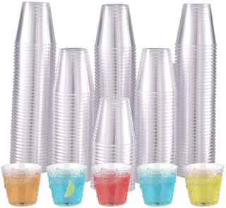 A collection of transparent Jolly Chef plastic cups stacked in varying heights with five colorful drinks in front, featuring ice and garnishes.