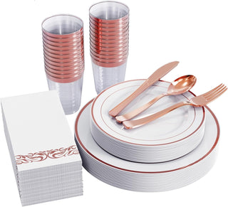 Rose gold plastic tableware: plates, cups, napkins, cutlery for party or event.